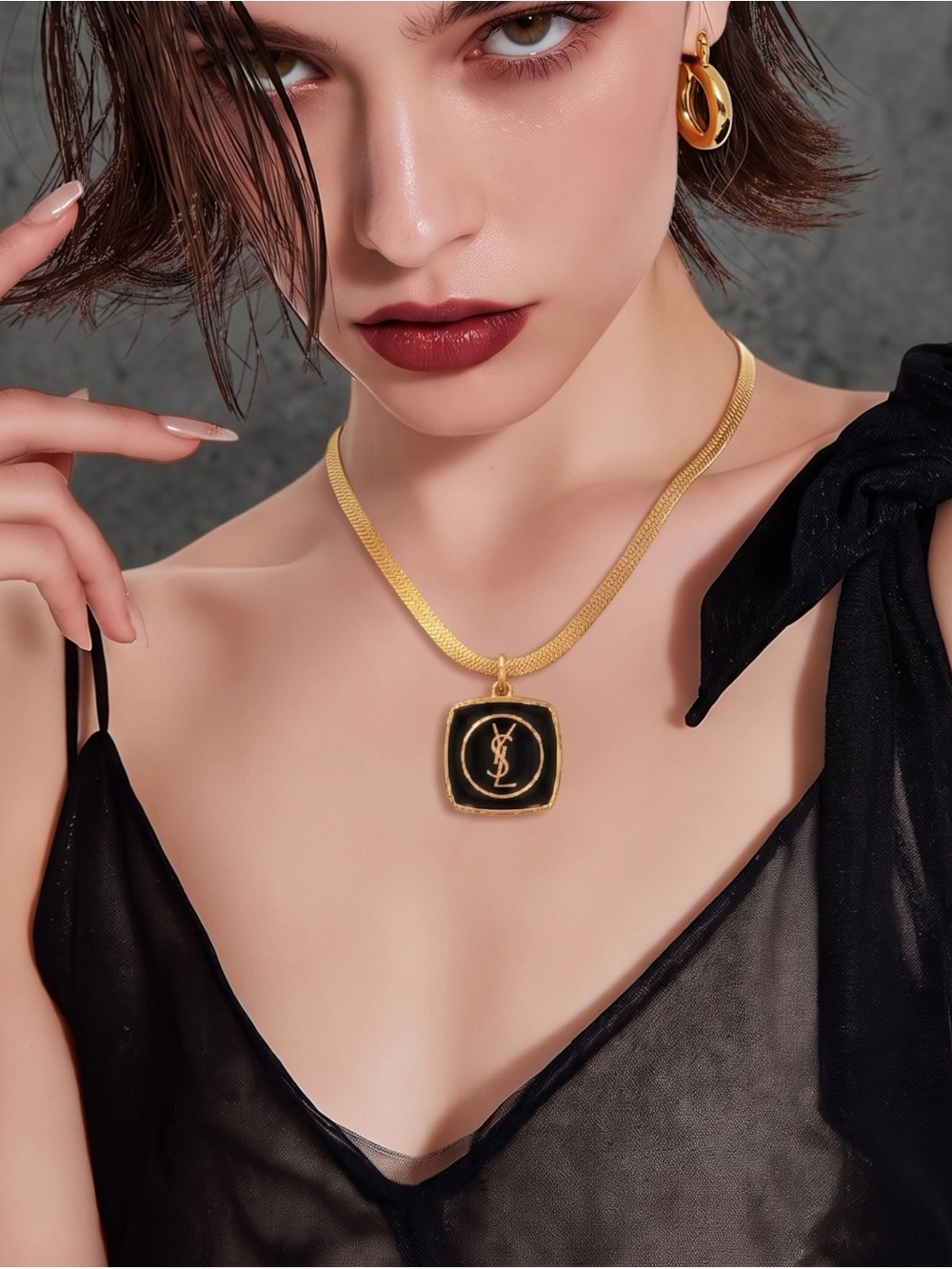 Gold-Tone Necklace with Black Enamel Pendant featuring Monogram Detail